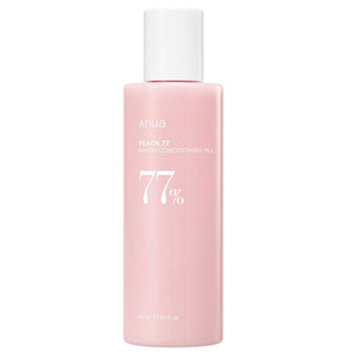 Anua Peach 77 Niacin Conditioning Milk emulsion bottle with peach-colored label and white cap, close-up view.