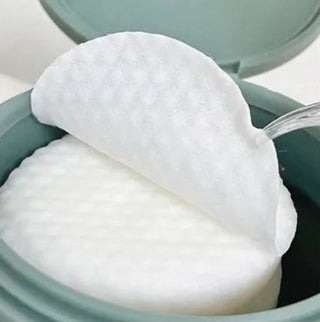 Anua Heartleaf 77 Clear Pad toner pads with natural ingredients, shown in a clear container with product label.