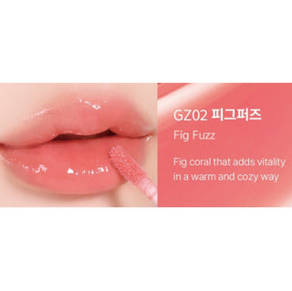 Black Rouge Chewy Lip Glaze lipstick in peach blossom shade, showing the sleek black tube and applicator with glossy finish.