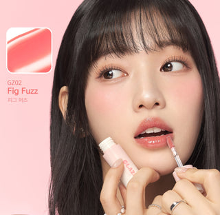 Black Rouge Chewy Lip Glaze lipstick in peach blossom shade, showing the sleek black tube and vibrant peach color.
