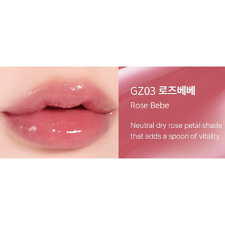 Black Rouge Chewy Lip Glaze lipstick in Peach Blossom, showing the sleek black tube and peach-colored lip gloss applicator.