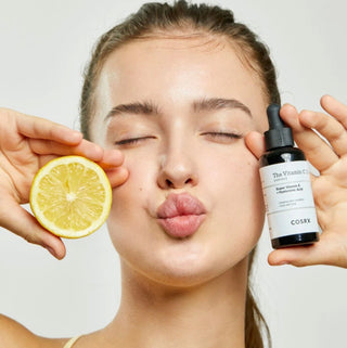 COSRX The Vitamin C 13 Serum bottle, clear packaging with orange liquid, highlighting skincare serum for brightening and antioxidant benefits.