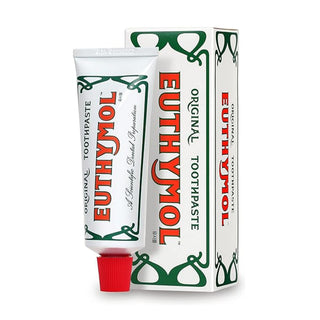 Euthymol Original fluoride-free toothpaste 75ml tube with bright red and white packaging, displayed on a bathroom countertop.