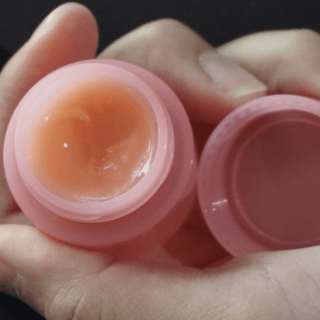 Laneige Lip Sleeping Mask EX in pink, a hydrating overnight lip treatment in a small jar, showcasing its smooth, glossy texture.