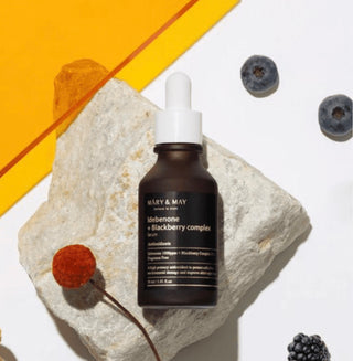 Mary&May Idebenone and Blackberry Complex Serum in a sleek glass bottle, showcasing the luxurious serum for radiant skin.