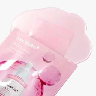 Medicube PDRN Pink Peptide Serum Mask sheet lying flat, showing packaging and product branding for skincare treatment.