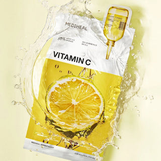 Mediheal Vitamin C Essential Face Sheet Mask lying flat, showing the packaged mask with vibrant citrus design and branding.