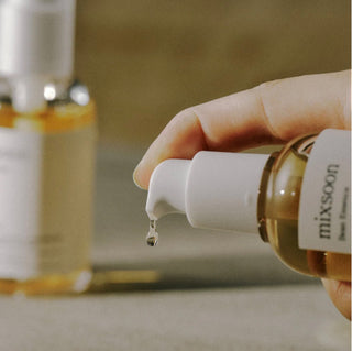 Mixsoon Bean Essence in a 30ml bottle, featuring clear liquid and minimalist label, designed for skincare.