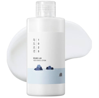 Round Lab 1025 Dokdo Lotion emulsion bottle with white and blue label, showcasing the skincare product in a clear container.