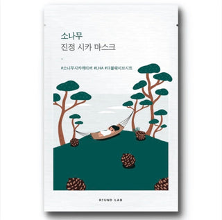 ROUND LAB Pine Calming Cica face sheet mask lying flat, showing the packaging with green pine design and product name.
