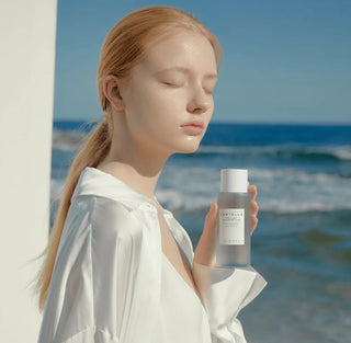 Skin1004 Madagascar Centella Hyalu-Cica Brightening Toner in a 30ml bottle, showing the clear liquid and branding.