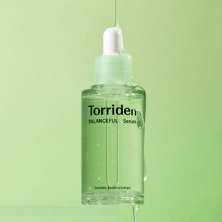 Torriden Balanceful Cica Serum 50mL in a clear bottle with a pump, featuring a minimalist design and light green label.
